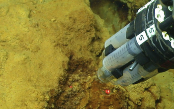 instrument collecting microbial mat samples from the seamount's iron-oxidizing bacteria